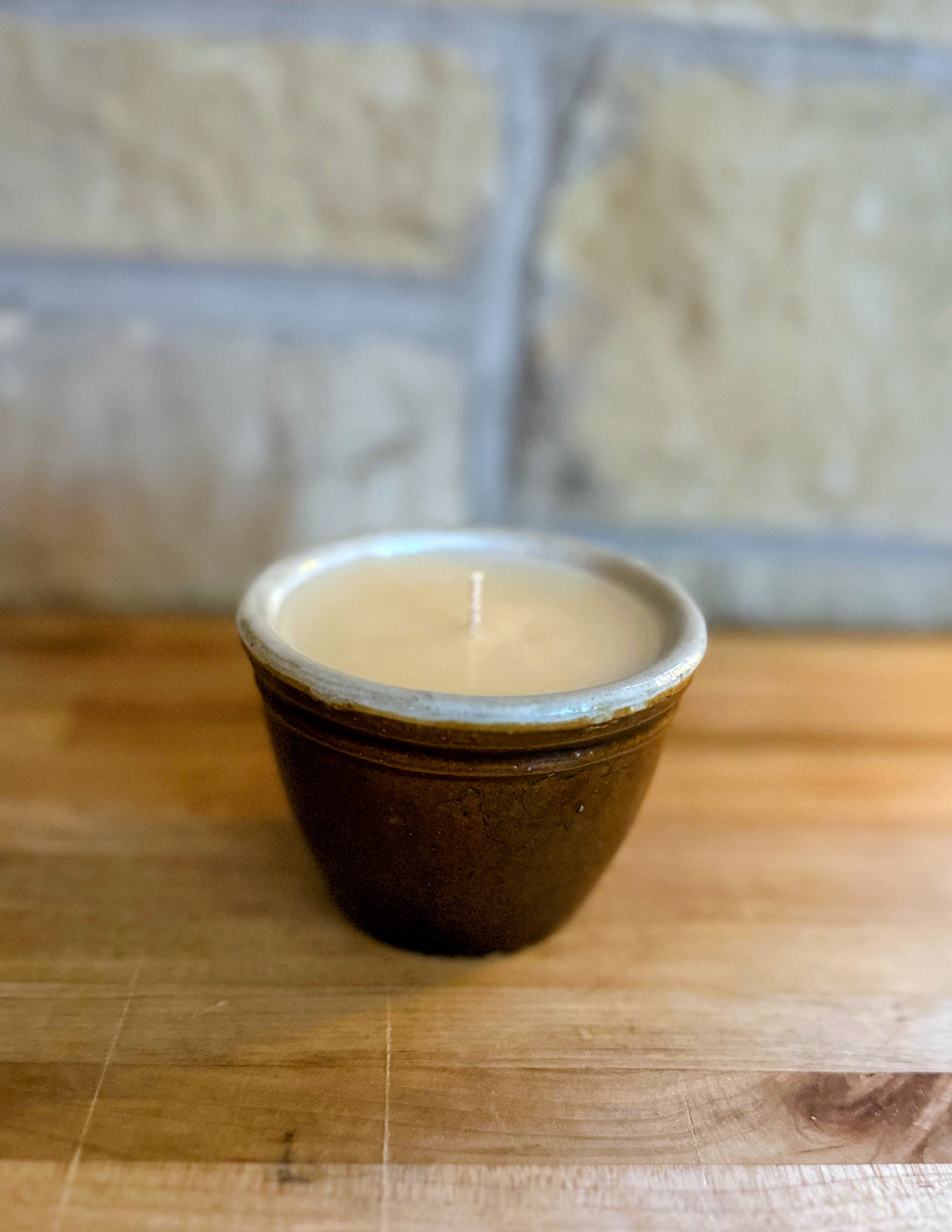 Small brown pottery candle